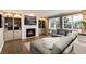 Cozy living room featuring a fireplace with built-in shelving and large windows at 49 Dawn Heath Cir, Littleton, CO 80127