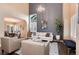 Elegant living room with high ceilings, large windows and stylish decor creating a welcoming atmosphere at 49 Dawn Heath Cir, Littleton, CO 80127