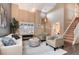 Comfortable living room with ample seating, large windows, and easy access to other rooms in the home at 49 Dawn Heath Cir, Littleton, CO 80127