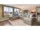 Comfortable living room with a large sectional sofa, hardwood floors, and seamless access to the kitchen at 49 Dawn Heath Cir, Littleton, CO 80127