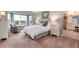 Airy main bedroom with bay window, sitting area, and en-suite bath with dual vanities at 49 Dawn Heath Cir, Littleton, CO 80127