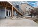 Back patio features a stone water feature, a stairway and a view of the outdoor lounge area at 49 Dawn Heath Cir, Littleton, CO 80127