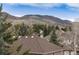 Scenic view of rolling hills beyond treetops, offering a peaceful residential backdrop at 49 Dawn Heath Cir, Littleton, CO 80127