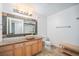 Bathroom with stone countertop vanity, decorative mirror, and tiled floors at 444 17Th St # 304, Denver, CO 80202