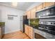 Kitchen featuring stainless steel appliances, light wood cabinets, and hardwood floors at 444 17Th St # 304, Denver, CO 80202