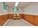 Basement room with wood paneling and small table and chairs at 9233 W Virginia Dr, Lakewood, CO 80226