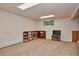 Finished basement with built-in shelving and TV area at 9233 W Virginia Dr, Lakewood, CO 80226