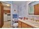 Bathroom with toilet, sink, and laundry room access at 9233 W Virginia Dr, Lakewood, CO 80226