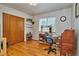 Bedroom with wood floors, large closet, and workspace at 9233 W Virginia Dr, Lakewood, CO 80226