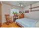 Bedroom with wood floors, ceiling fan, and rocking chair at 9233 W Virginia Dr, Lakewood, CO 80226