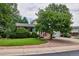 Ranch-style home with landscaped yard and attached garage at 9233 W Virginia Dr, Lakewood, CO 80226