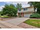 Ranch style home with brick facade, attached garage, and mature landscaping at 9233 W Virginia Dr, Lakewood, CO 80226