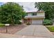 Two-story home with a covered entry and attached garage at 9233 W Virginia Dr, Lakewood, CO 80226