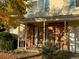 Inviting front entrance with brick facade and covered porch at 9233 W Virginia Dr, Lakewood, CO 80226