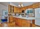 Spacious kitchen with wood cabinets, island, and hardwood floors at 9233 W Virginia Dr, Lakewood, CO 80226