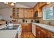 Kitchen with wood cabinets, ample counter space, and appliances at 9233 W Virginia Dr, Lakewood, CO 80226