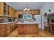 Well-equipped kitchen with wood cabinets, island, and hardwood floors at 9233 W Virginia Dr, Lakewood, CO 80226