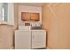 Laundry room with washer, dryer, and overhead cabinets at 9233 W Virginia Dr, Lakewood, CO 80226