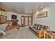 Cozy living room featuring a brick fireplace, wood floors, and access to a patio at 9233 W Virginia Dr, Lakewood, CO 80226