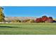 Addenbrooke Park with open green space and distant mountain views at 9233 W Virginia Dr, Lakewood, CO 80226