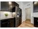 Well-lit kitchen featuring stainless steel appliances, granite countertops, and dark wood cabinetry at 8937 Red Bud St, Parker, CO 80134