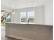 Kitchen bar featuring a quartz countertop, pendant lighting and community views at 4716 Twelve Oaks Way, Castle Rock, CO 80104