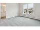 Bright bedroom with plush gray carpeting and large windows offering neighborhood views at 4716 Twelve Oaks Way, Castle Rock, CO 80104