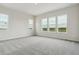 Bright bedroom with neutral carpet and multiple windows offering community views at 4716 Twelve Oaks Way, Castle Rock, CO 80104