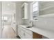 Stylish wet bar featuring white cabinetry, quartz countertops, and stainless steel faucet at 4716 Twelve Oaks Way, Castle Rock, CO 80104