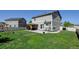 Large backyard featuring green lawn, privacy fence, patio area with pergola, and play set at 11158 Carbondale St, Firestone, CO 80504