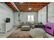 Basement featuring exposed ceiling, finished area with furniture and a large rug, perfect for relaxing at 11158 Carbondale St, Firestone, CO 80504
