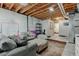Spacious basement featuring exposed ceiling, finished area with furniture and a large rug, perfect for relaxing at 11158 Carbondale St, Firestone, CO 80504