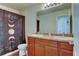 Bathroom featuring double vanity, a moon-themed shower curtain, and modern fixtures at 11158 Carbondale St, Firestone, CO 80504