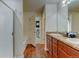 Bright bathroom with dual sinks, spacious shower, and a view into the bedroom at 11158 Carbondale St, Firestone, CO 80504