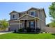 Charming two-story home with manicured lawn, covered porch, and attached garage at 11158 Carbondale St, Firestone, CO 80504