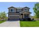 Beautiful two-story home featuring a well-maintained lawn and attached two car garage at 11158 Carbondale St, Firestone, CO 80504