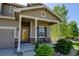 Inviting front porch with stylish seating and decorative stone accents on the facade at 11158 Carbondale St, Firestone, CO 80504