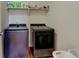 Modern laundry room featuring front loading washer and dryer with shelf for storage at 11158 Carbondale St, Firestone, CO 80504