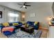 Comfortable living room with a blue sectional couch, stylish coffee table, and patterned rug at 11158 Carbondale St, Firestone, CO 80504