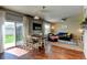 Living and dining area with hardwood floors, seamless flow, and access to the backyard at 11158 Carbondale St, Firestone, CO 80504