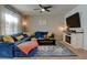 Inviting living room featuring a blue sectional, modern television, and decorative fireplace at 11158 Carbondale St, Firestone, CO 80504