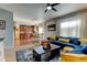 Open-concept living room connected to kitchen, showcasing comfortable seating and natural light at 11158 Carbondale St, Firestone, CO 80504