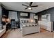 Stylish bedroom featuring dark accent wall, modern fan, work desk, and decor at 11158 Carbondale St, Firestone, CO 80504