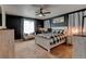 Serene bedroom with dark accent wall, plush bedding, and a cozy seating area at 11158 Carbondale St, Firestone, CO 80504