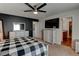 Spacious bedroom featuring a cozy bed, TV, walk-in closet, and en-suite bathroom at 11158 Carbondale St, Firestone, CO 80504