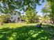 Expansive backyard with lush lawn, patio, and mature trees providing shade and privacy at 21351 E Williamette Pl, Centennial, CO 80015