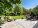 A serene backyard with a lush lawn and an outdoor dining and seating area at 21351 E Williamette Pl, Centennial, CO 80015