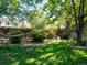 Beautifully landscaped backyard featuring a privacy fence, mature shrubs, and a relaxing hammock at 21351 E Williamette Pl, Centennial, CO 80015