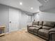 Finished basement area with plush seating, a door, and neutral carpeting at 21351 E Williamette Pl, Centennial, CO 80015