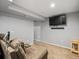 Finished basement area with seating and a mounted TV at 21351 E Williamette Pl, Centennial, CO 80015